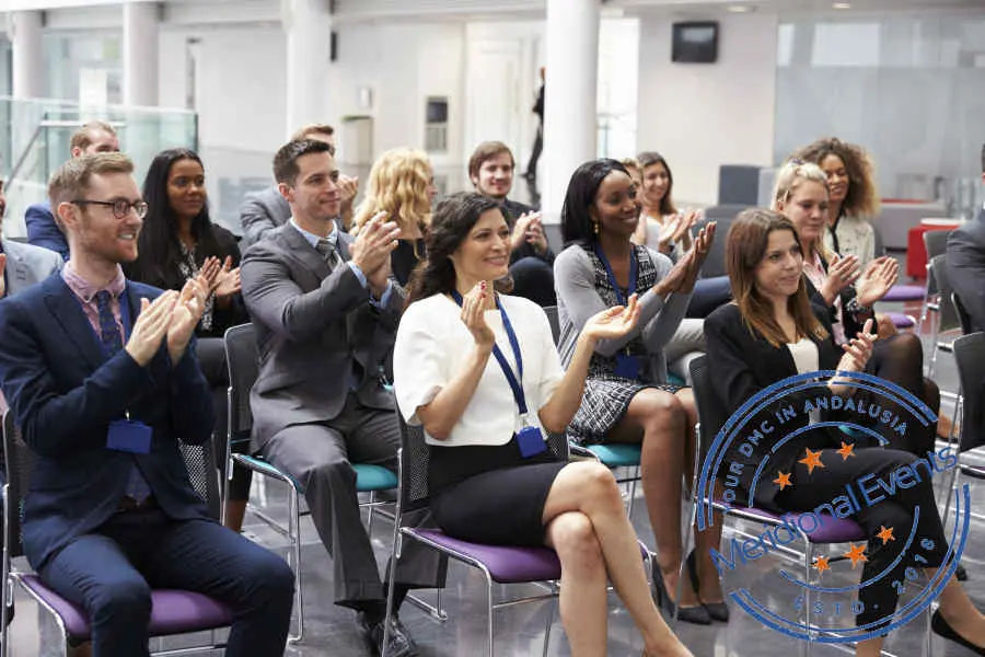 Audience applauding after conference presentation